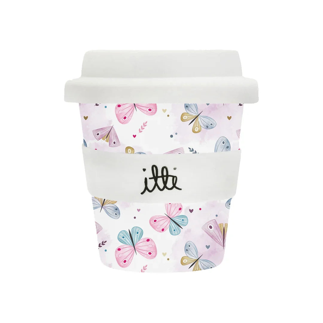 Baby cino cup with two straws with a white and pink watercolour background. It then has pastel coloured rainbow butterflies and hearts. It comes with two straws and is the perfect first birthday gift.